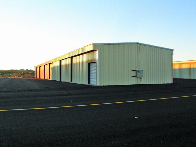 (Clockwise from top left) Agate, Inc. built 14 hangars at Ryan Field Airpark in Tucson, Ariz.; three executive hangars and 10 nested hangars with bi-fold doors at the airport in Kingman, Ariz.; and six T-hangars with 38-foot sliding doors at the Wickenburg, Ariz., airport. 
Agate, Inc. photos
